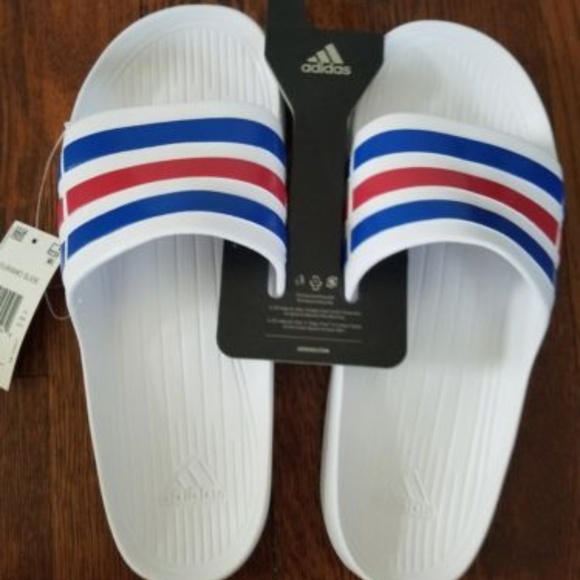 red white and blue adidas slides